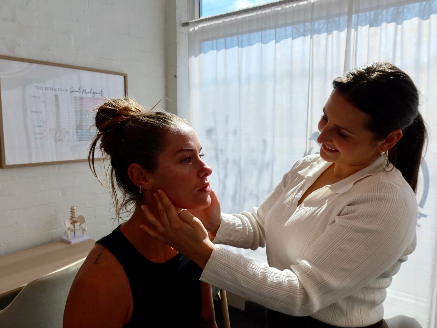 Chiropractor assessing jaw and TMJ area