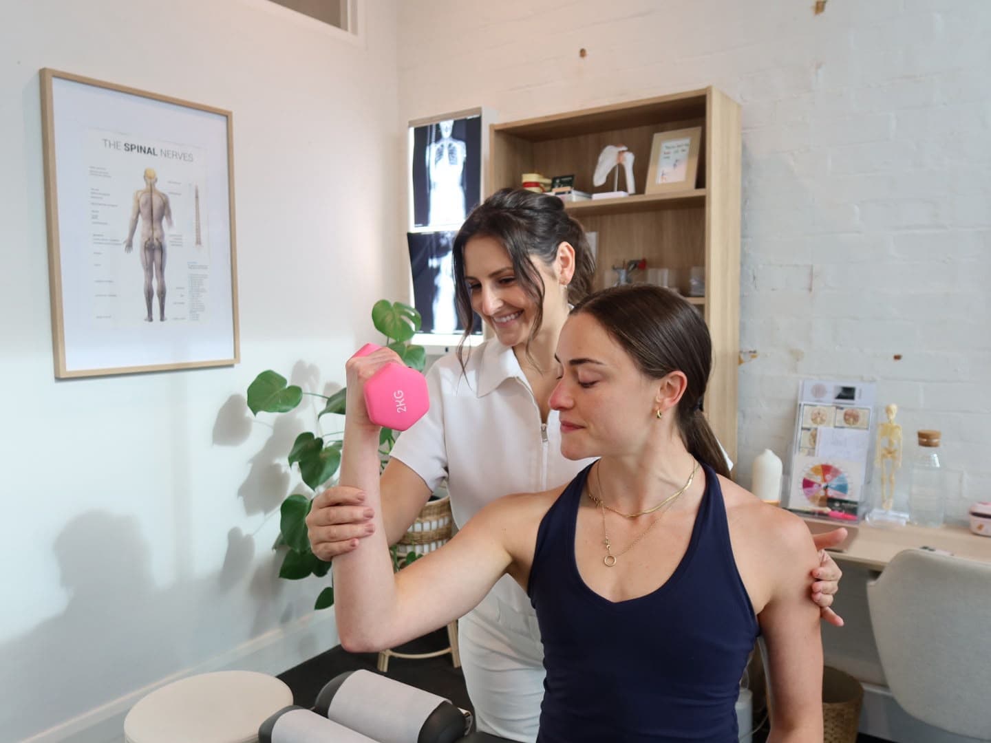 Chiropractor guiding a patient through a shoulder mobility assessment